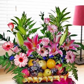 Pink Lily, Gerbera & Roses Fruits Basket Arrangement